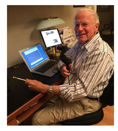 Bob Gallagher at desk with microphone