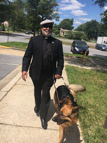 Rev Ray Raysor walking with guide dog